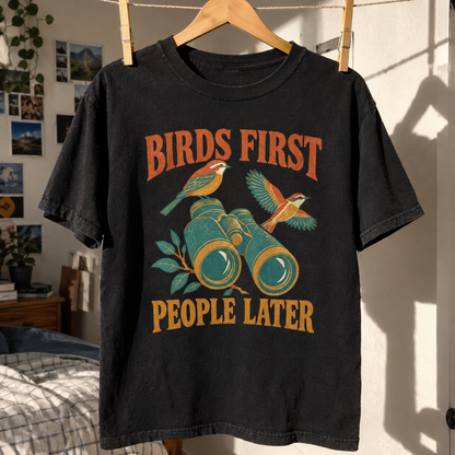 Black vintage t-shirt hanging with printed Birds First. People Later slogan and bird binoculars design