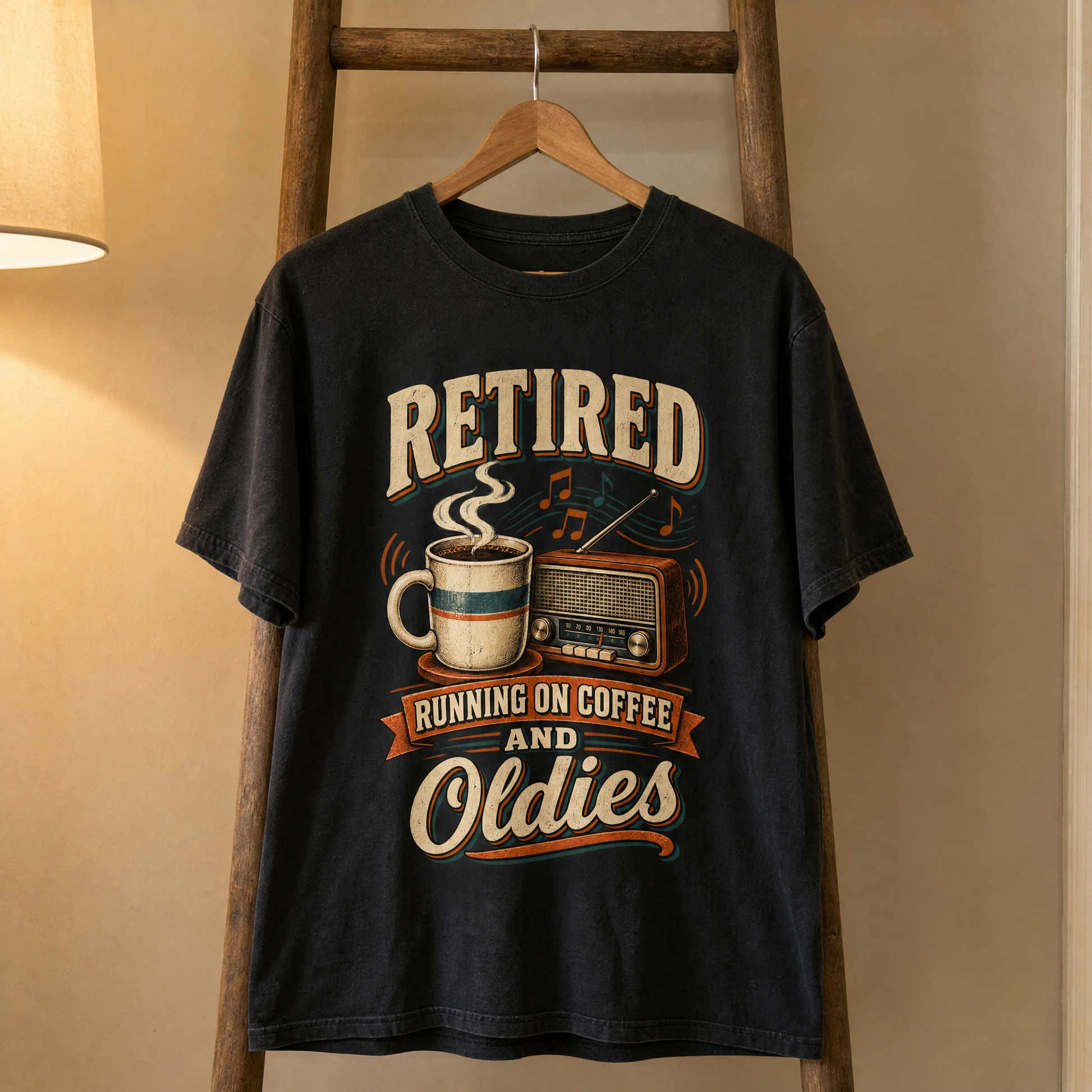 Black vintage t-shirt hanging with printed “Retired Running on Coffee and Oldies” slogan