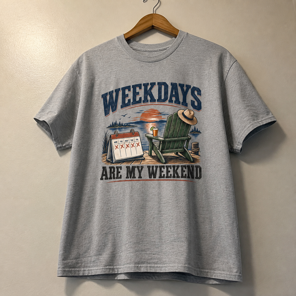 Gray vintage t-shirt hanging with printed Weekdays Are My Weekend slogan and lakeside design