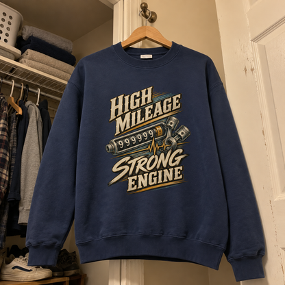 Navy vintage sweatshirt hanging on a hanger with printed High Mileage Strong Engine graphic.