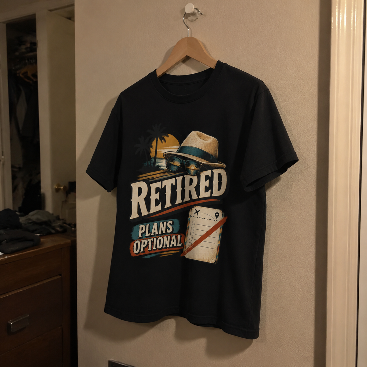 Black vintage t-shirt hanging with printed Retired Plans Optional design and retro hat graphic