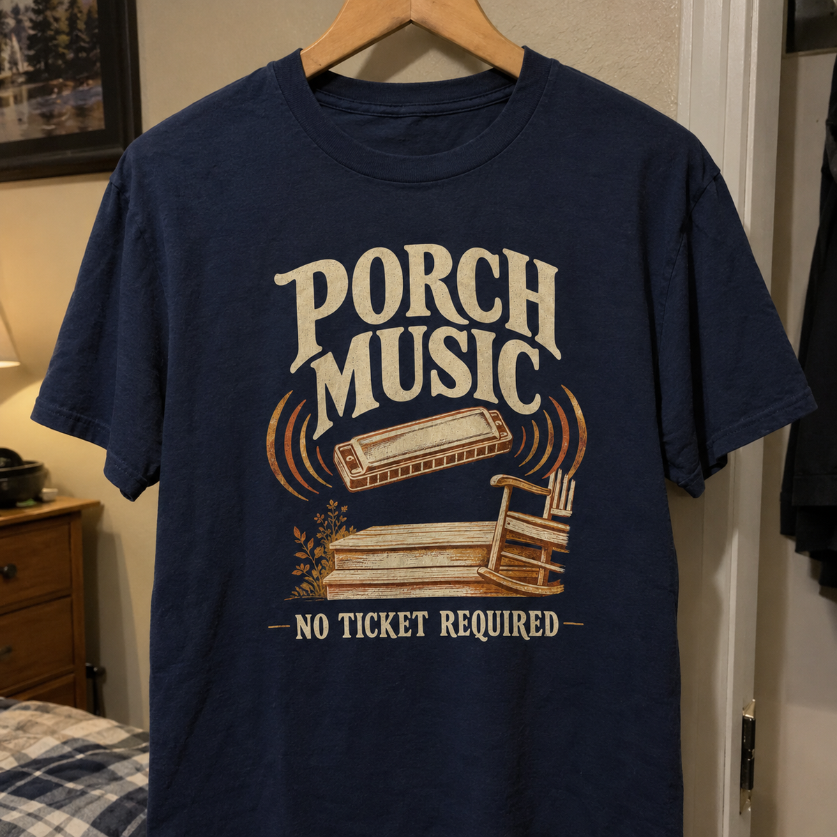 Navy vintage t-shirt hanging with printed Porch Music. No Ticket Required design and harmonica illustration