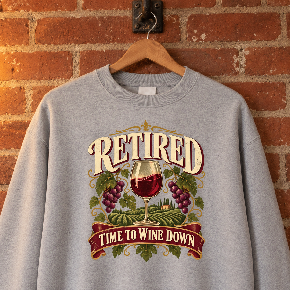 Gray vintage sweatshirt hanging against brick wall with printed Retired Time To Wine Down
