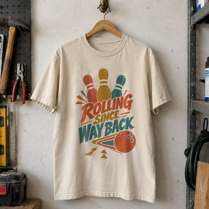 Vintage t-shirt hanging, cream with printed bowling pins, ball, and Bowling Since Way Back slogan