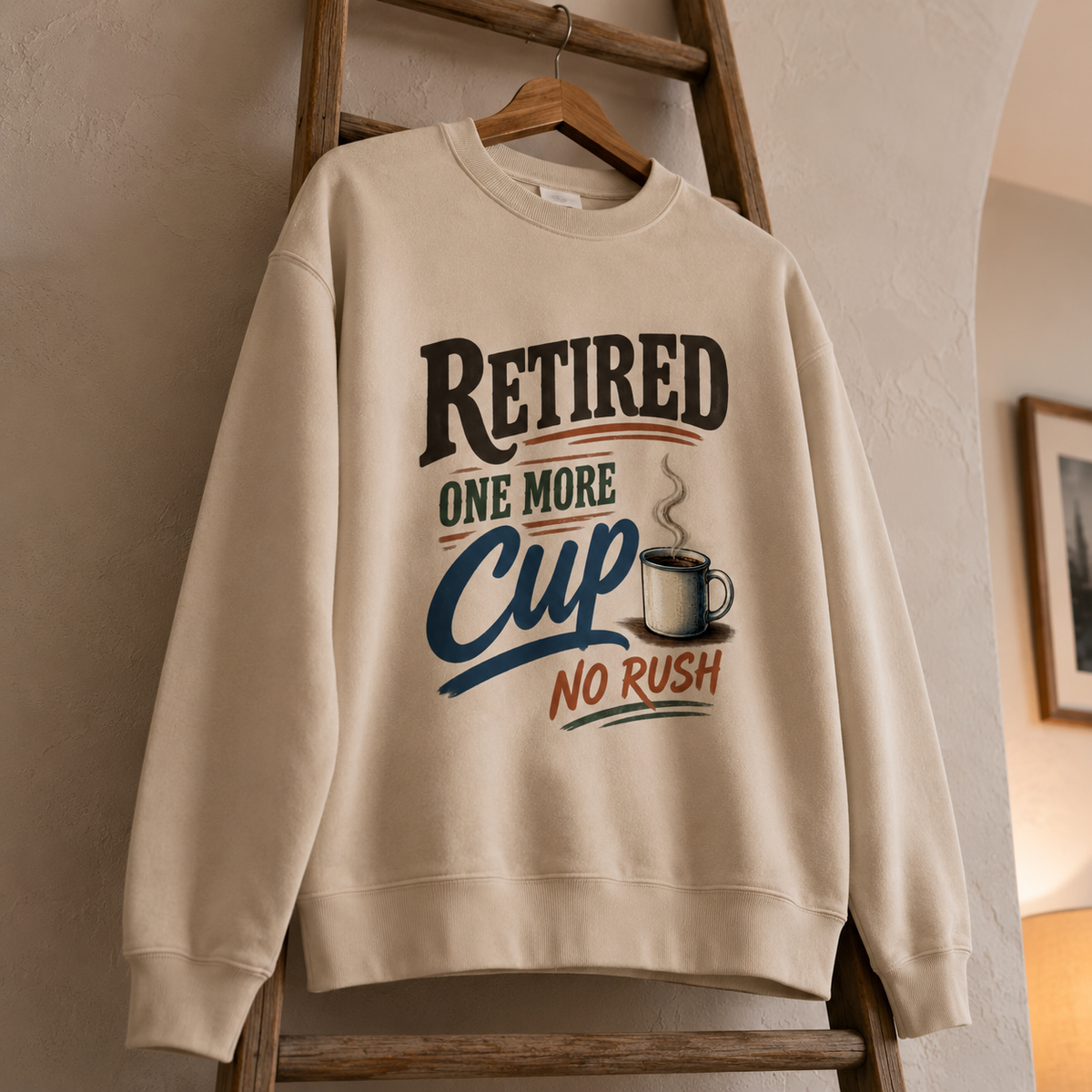 Cream vintage sweatshirt hanging with printed Retired One More Cup No Rush design