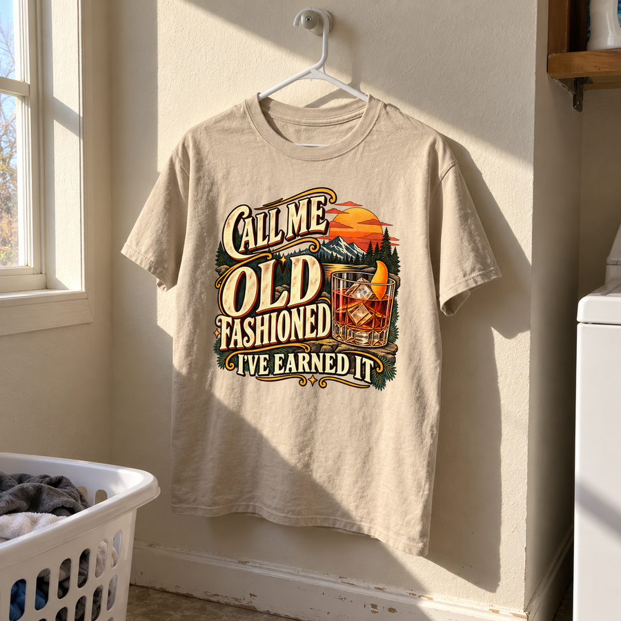 Beige vintage t-shirt hanging with printed Call Me Old Fashioned I’ve Earned It slogan.