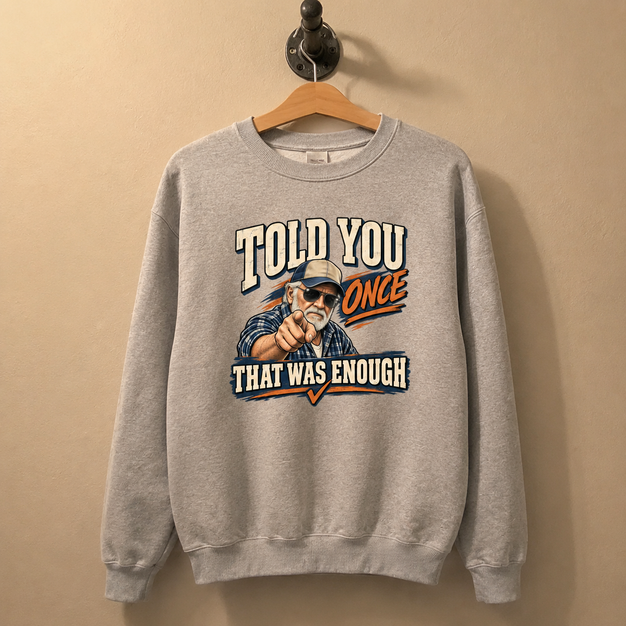 Gray vintage sweatshirt hanging with printed Told You Once That Was Enough slogan design