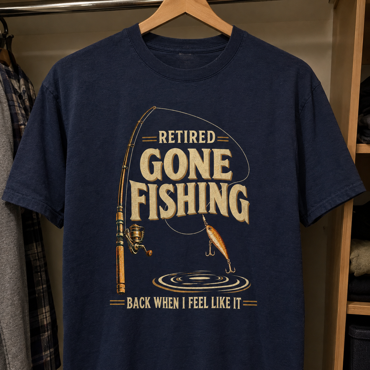 Navy vintage t-shirt hanging with printed fishing design and Retired Gone Fishing slogan