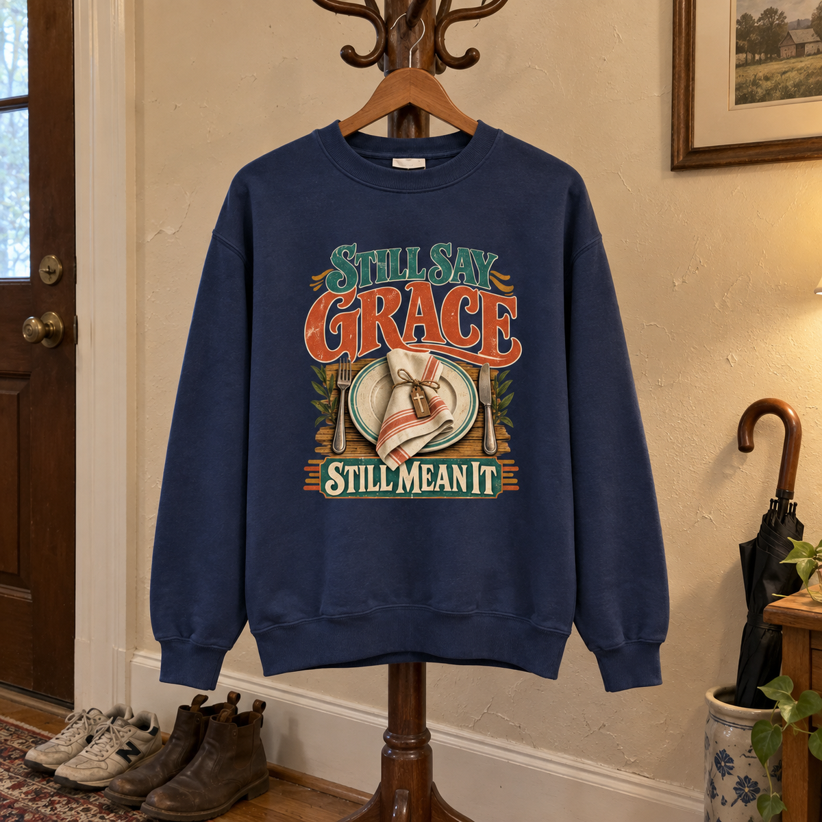 Navy vintage sweatshirt hanging with printed Still Say Grace Still Mean It design