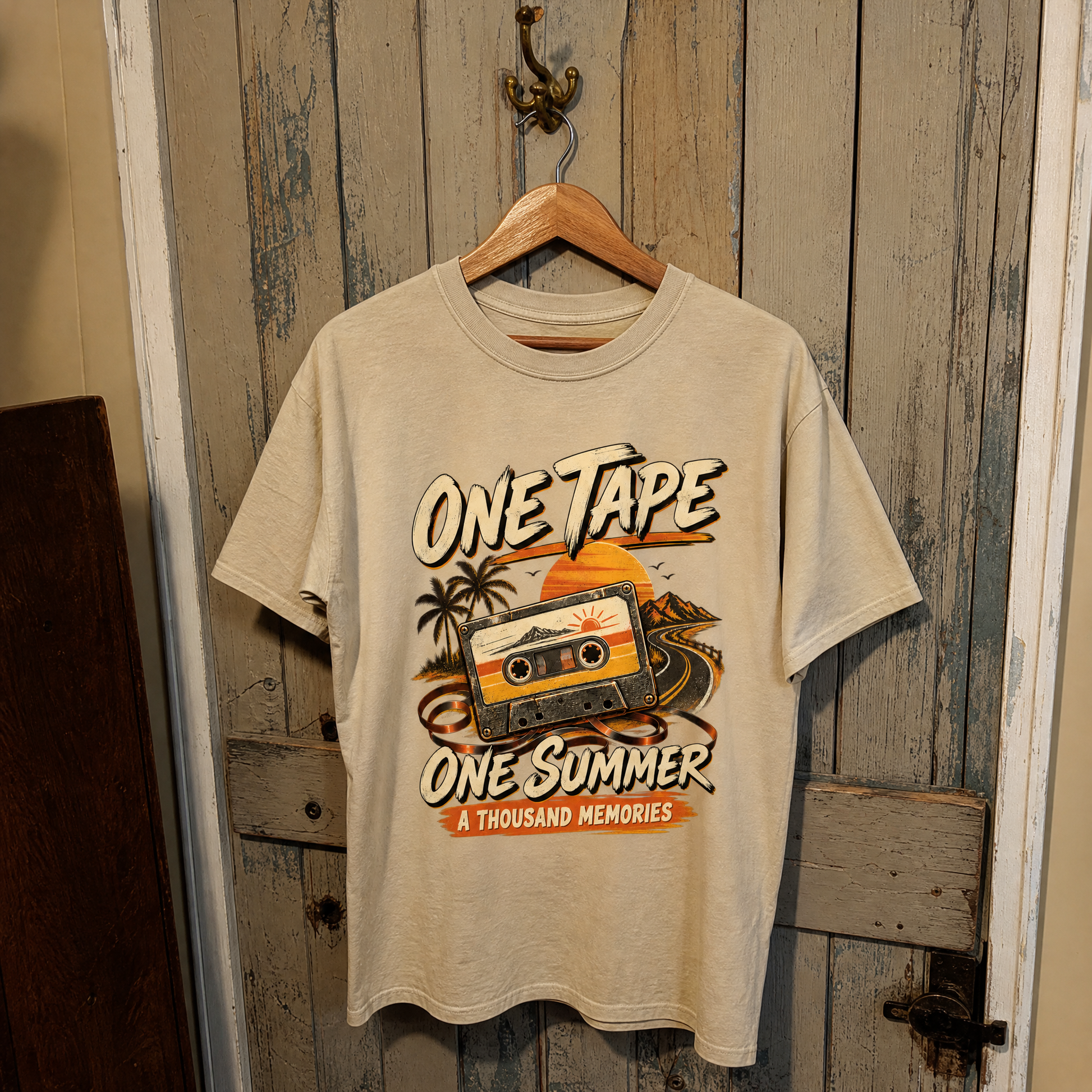 Beige vintage t-shirt hanging with printed One Tape One Summer A Thousand Memories cassette design