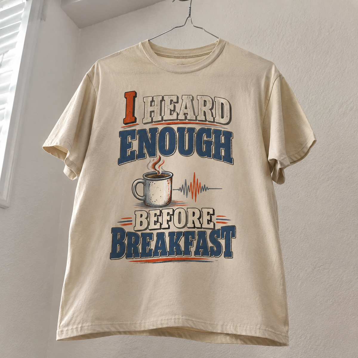 Cream vintage t-shirt hanging with printed I Heard Enough Before Breakfast slogan