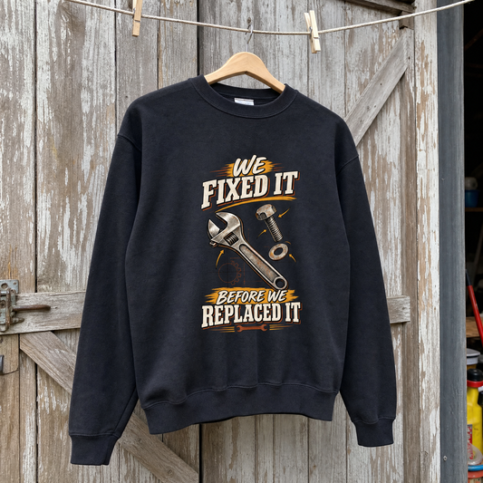 Vintage sweatshirt hanging with printed “We Fixed It Before We Replaced It” slogan