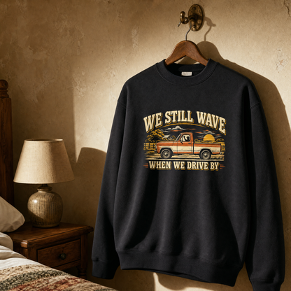 vintage sweatshirt on hanger with We Still Wave When We Drive By printed design