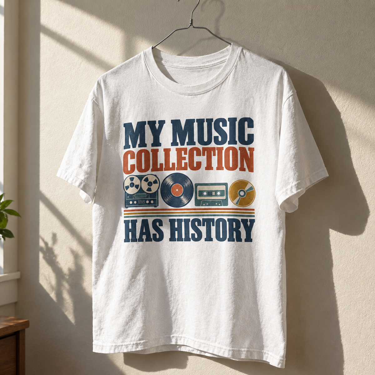 Vintage t-shirt hanging with printed My Music Collection Has History slogan and retro music designs