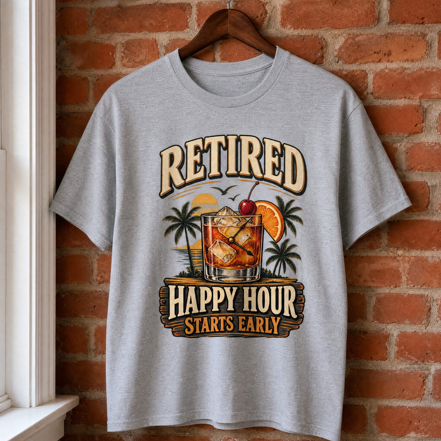 Gray vintage t-shirt hanging with printed Retired Happy Hour Starts Early slogan and cocktail design