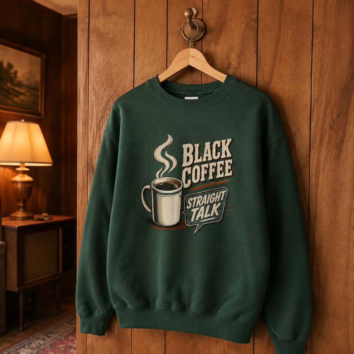 Green vintage sweatshirt hanging with printed Black Coffee Straight Talk design and coffee mug graphic