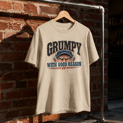 Cream vintage t-shirt with printed Grumpy With Good Reason slogan hanging on brick wall