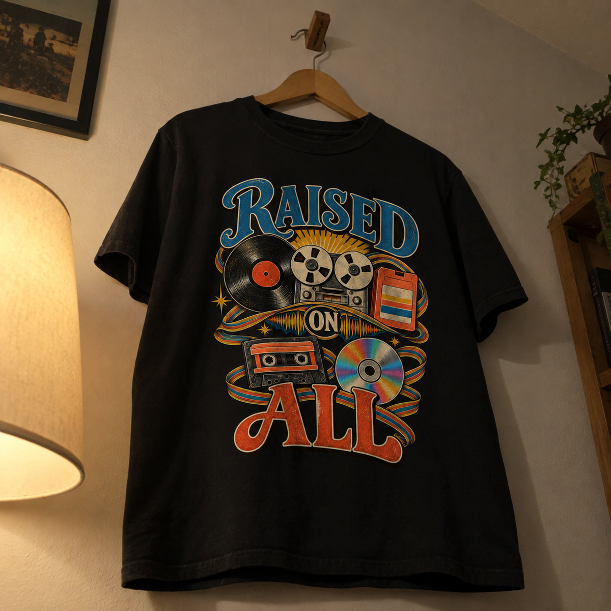 Black vintage t-shirt with printed Raised On All design hanging on wooden hanger