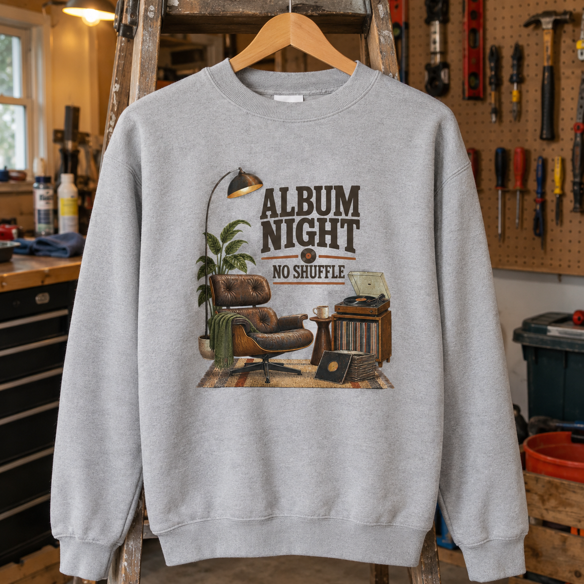 Gray vintage sweatshirt hanging, printed with Album Night. No Shuffle and a retro record-player scene.