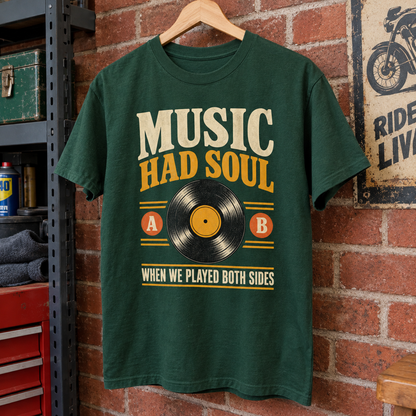 Green vintage t-shirt hanging with printed “Music Had Soul When We Played Both Sides”