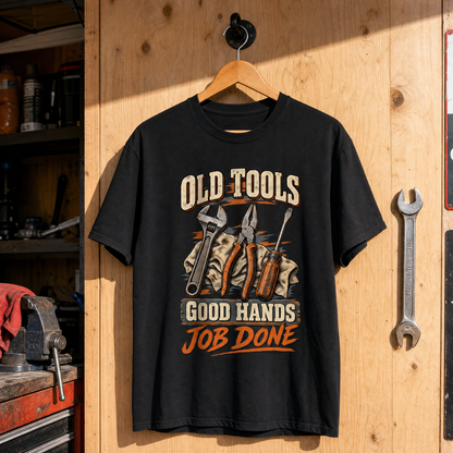 Black vintage t-shirt hanging with printed Old Tools Good Hands Job Done design, tools graphic