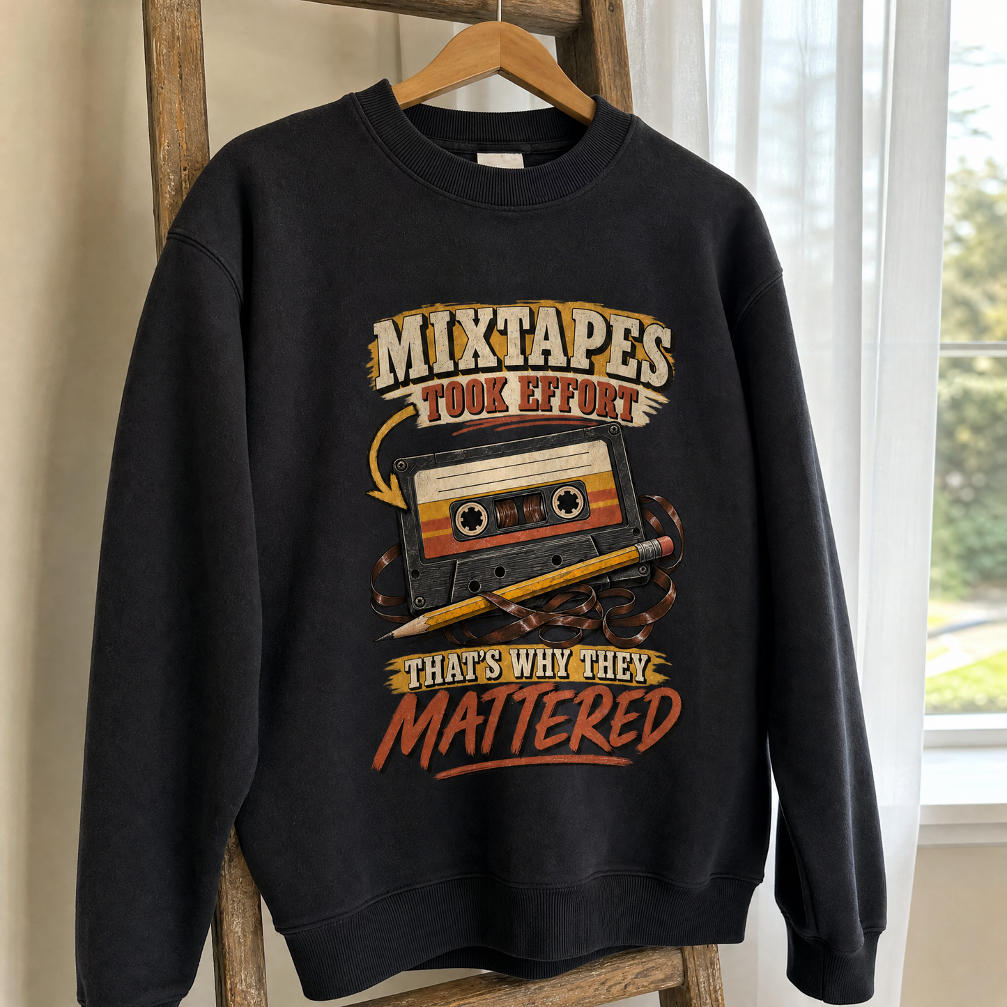 Black vintage sweatshirt hanging with printed mixtape slogan and cassette design.