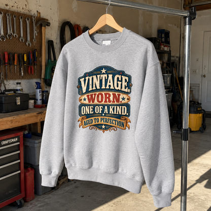 Gray vintage sweatshirt hanging in garage with printed Vintage Worn One of a Kind design