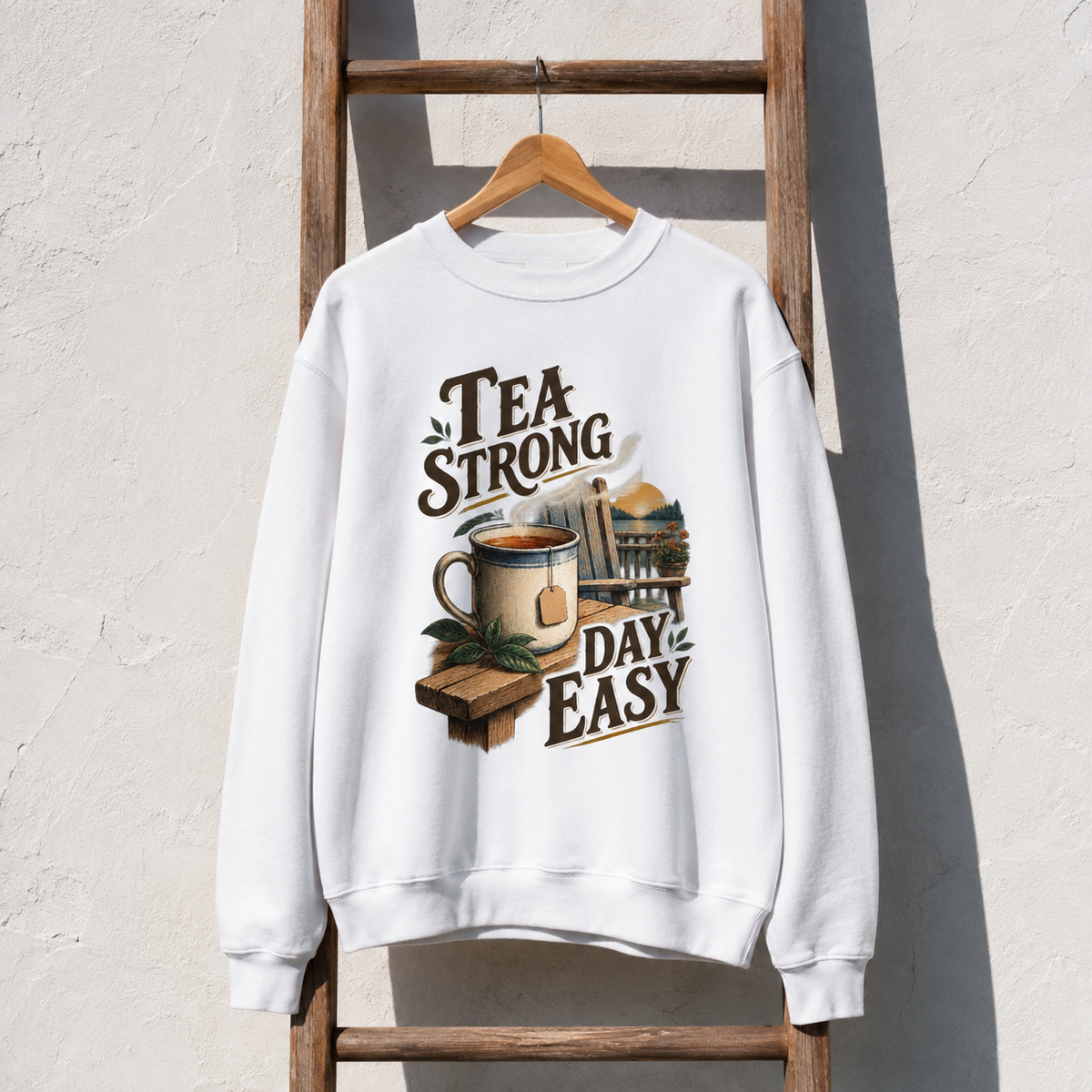 White vintage sweatshirt hanging with printed Tea Strong Day Easy design