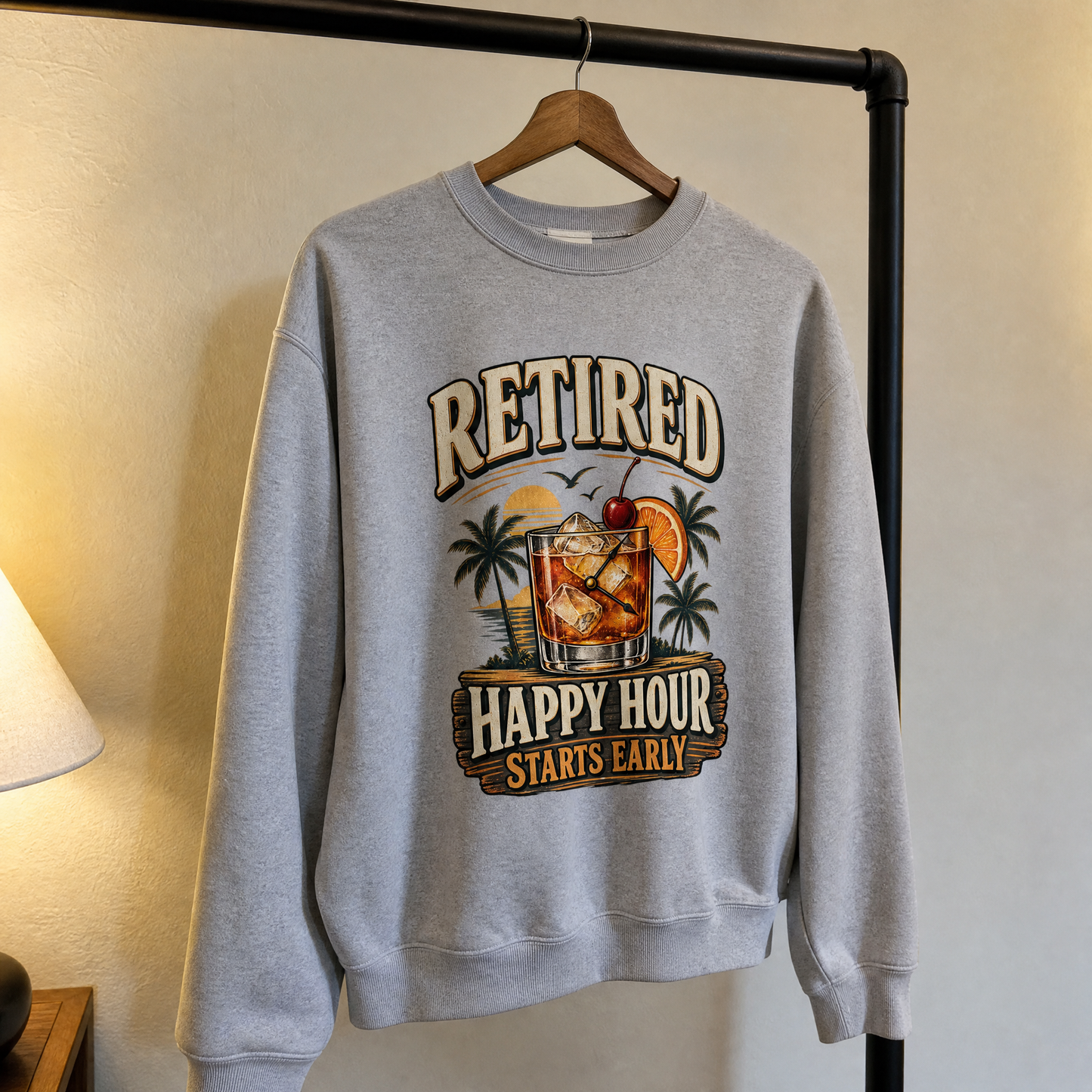 Gray vintage sweatshirt with printed “Retired Happy Hour Starts Early” design, hanging front view