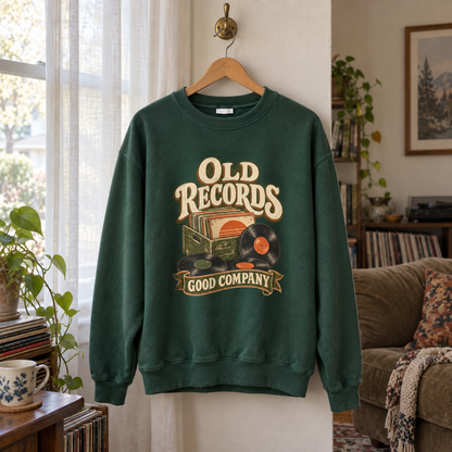 Forest green vintage sweatshirt hanging on hanger with printed Old Records Good Company vinyl design