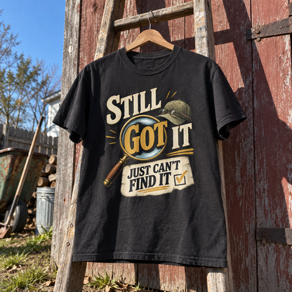 Black vintage t-shirt hanging outdoors with printed Still Got It Just Can't Find It slogan
