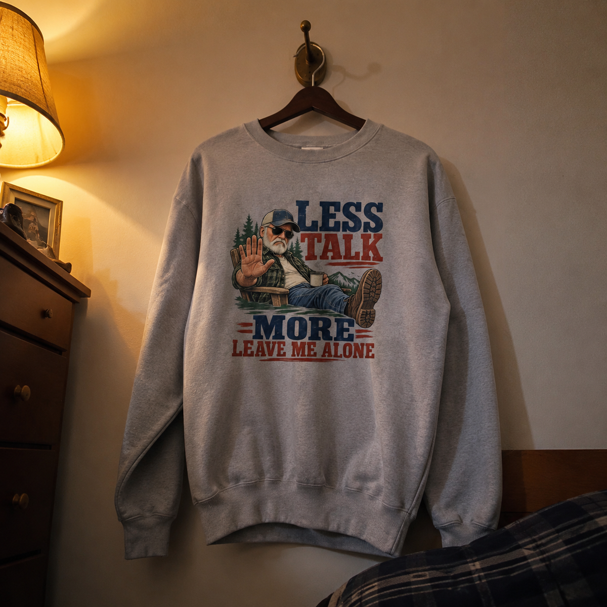 Vintage sweatshirt hanging with printed Less Talk More Leave Me Alone slogan design