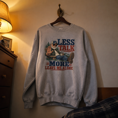 Vintage sweatshirt hanging with printed Less Talk More Leave Me Alone slogan design
