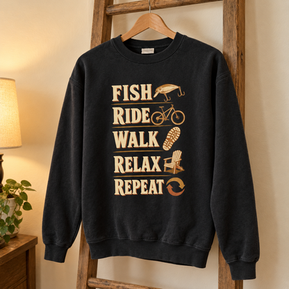 Black vintage sweatshirt hanging with printed Fish Ride Walk Relax Repeat slogan and outdoor activity graphics