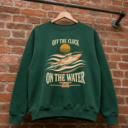 Dark green vintage sweatshirt with printed “Off The Clock On The Water” boat design, hanging front view