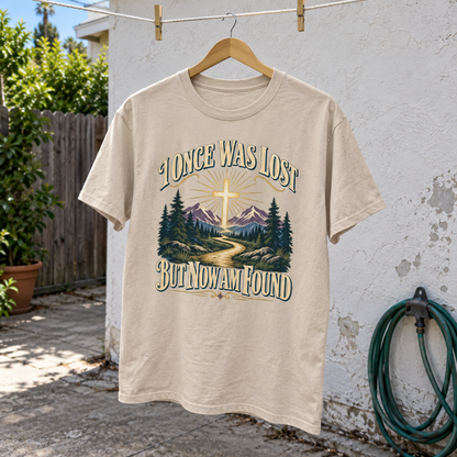 Cream vintage t-shirt hanging outdoors, printed with I Once Was Lost But Now Am Found