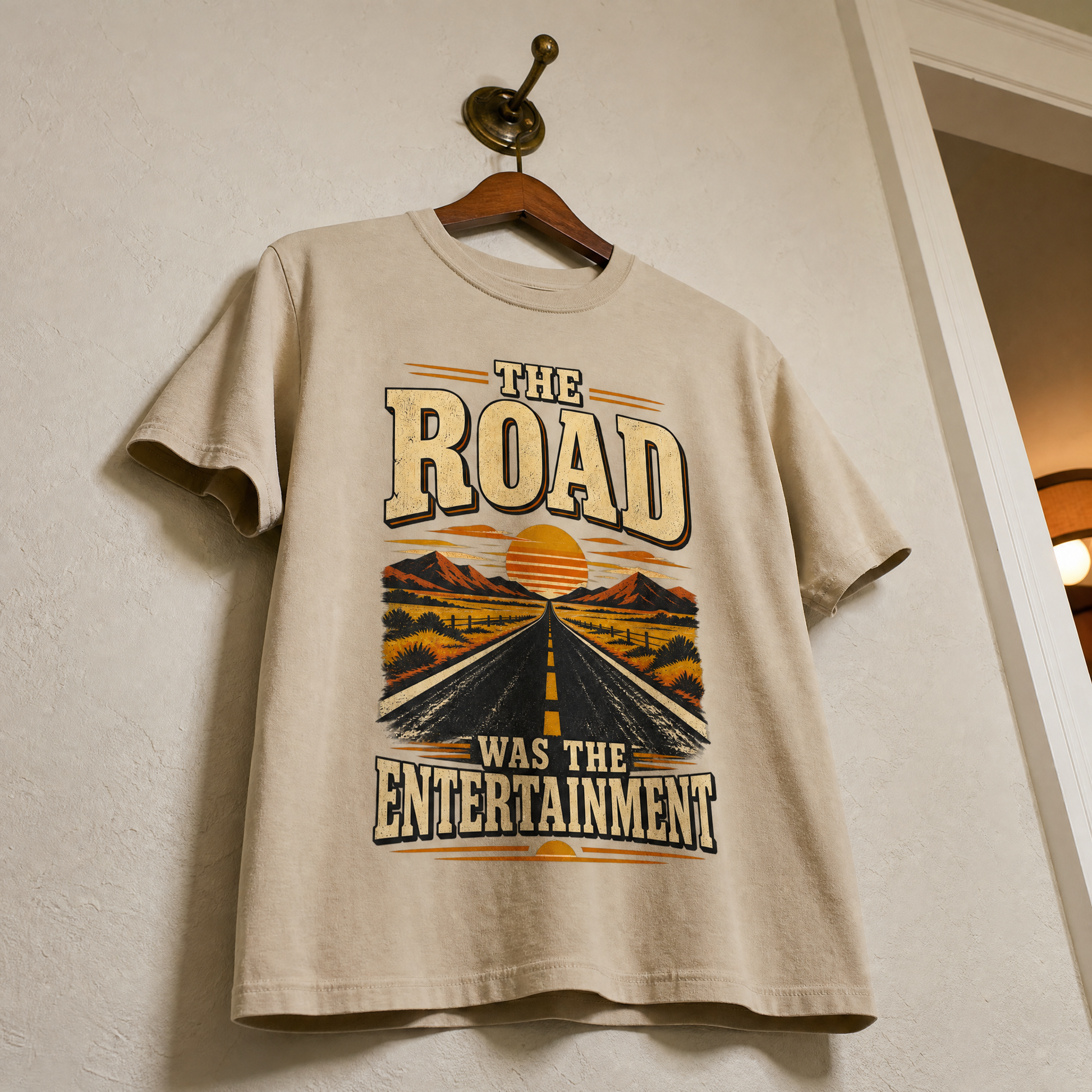Beige vintage t-shirt hanging with printed The Road Was The Entertainment highway design