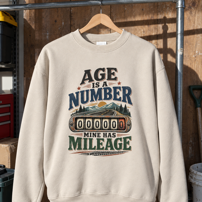 Cream vintage sweatshirt hanging with printed Age Is A Number Mine Has Mileage design