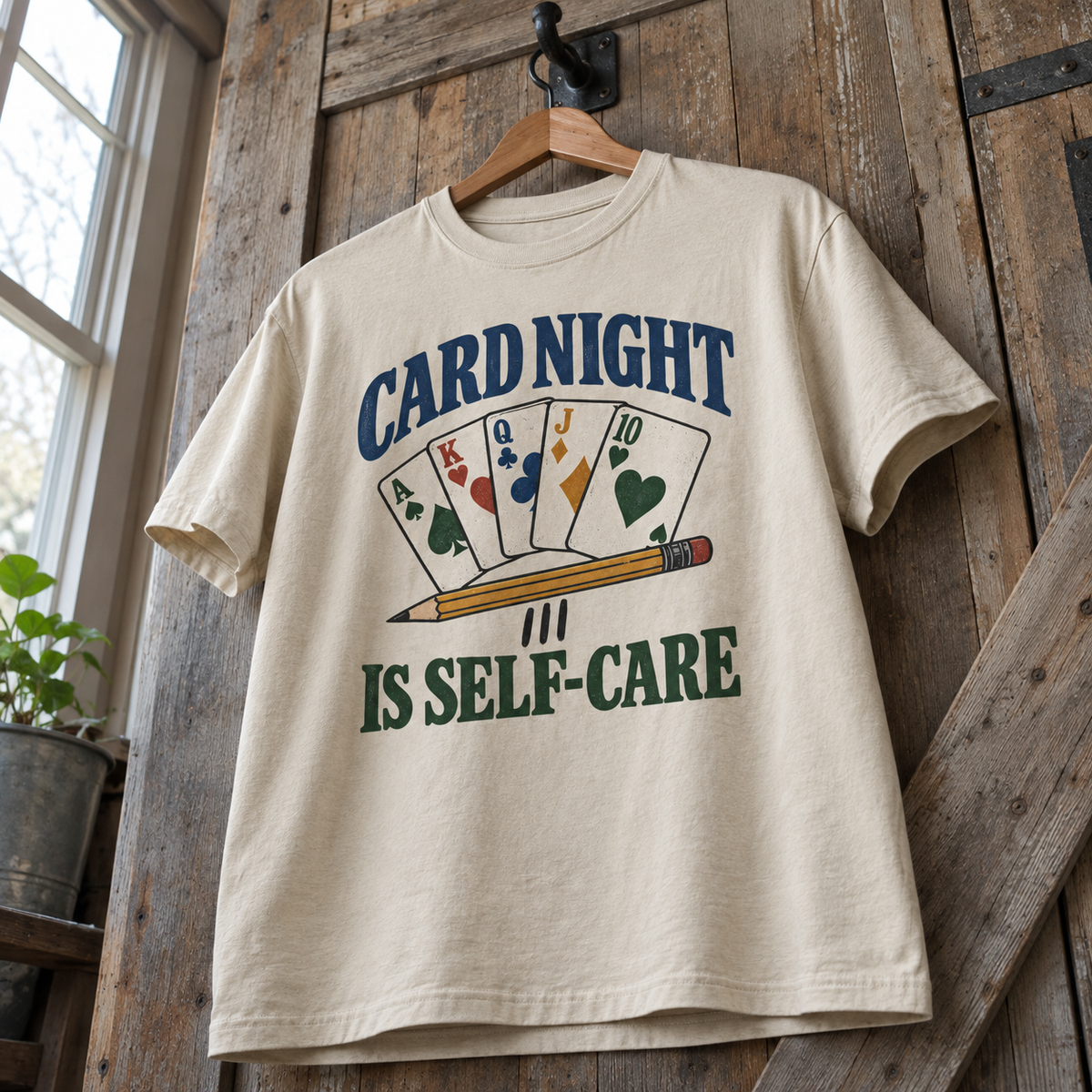 Cream vintage t-shirt hanging with printed Card Night Is Self-Care card design