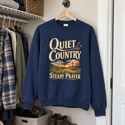Navy vintage sweatshirt hanging in closet with printed Quiet Country Steady Prayer sunset design