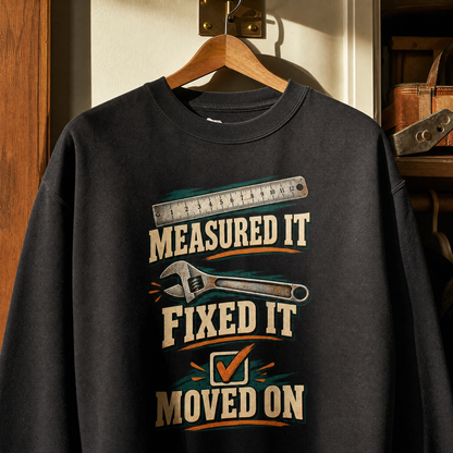 Black vintage sweatshirt hanging with printed Measured It Fixed It Moved On design