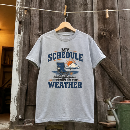Gray vintage t-shirt hanging with printed My Schedule Depends On The Weather design