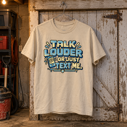 Cream vintage t-shirt hanging before wooden door, printed Talk Louder Or Just Text Me