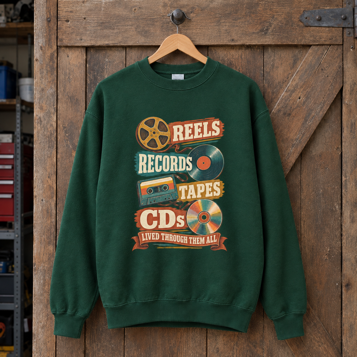 Green vintage sweatshirt hanging with printed Reels Records Tapes CDs music design