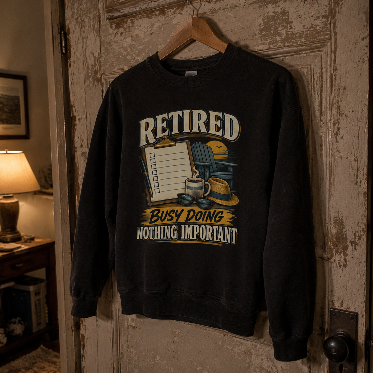 Black vintage sweatshirt hanging on a hanger with printed Retired. Busy Doing Nothing Important slogan