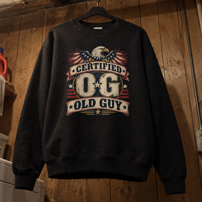 Black vintage sweatshirt hanging on a hanger with printed Certified OG Old Guy eagle design