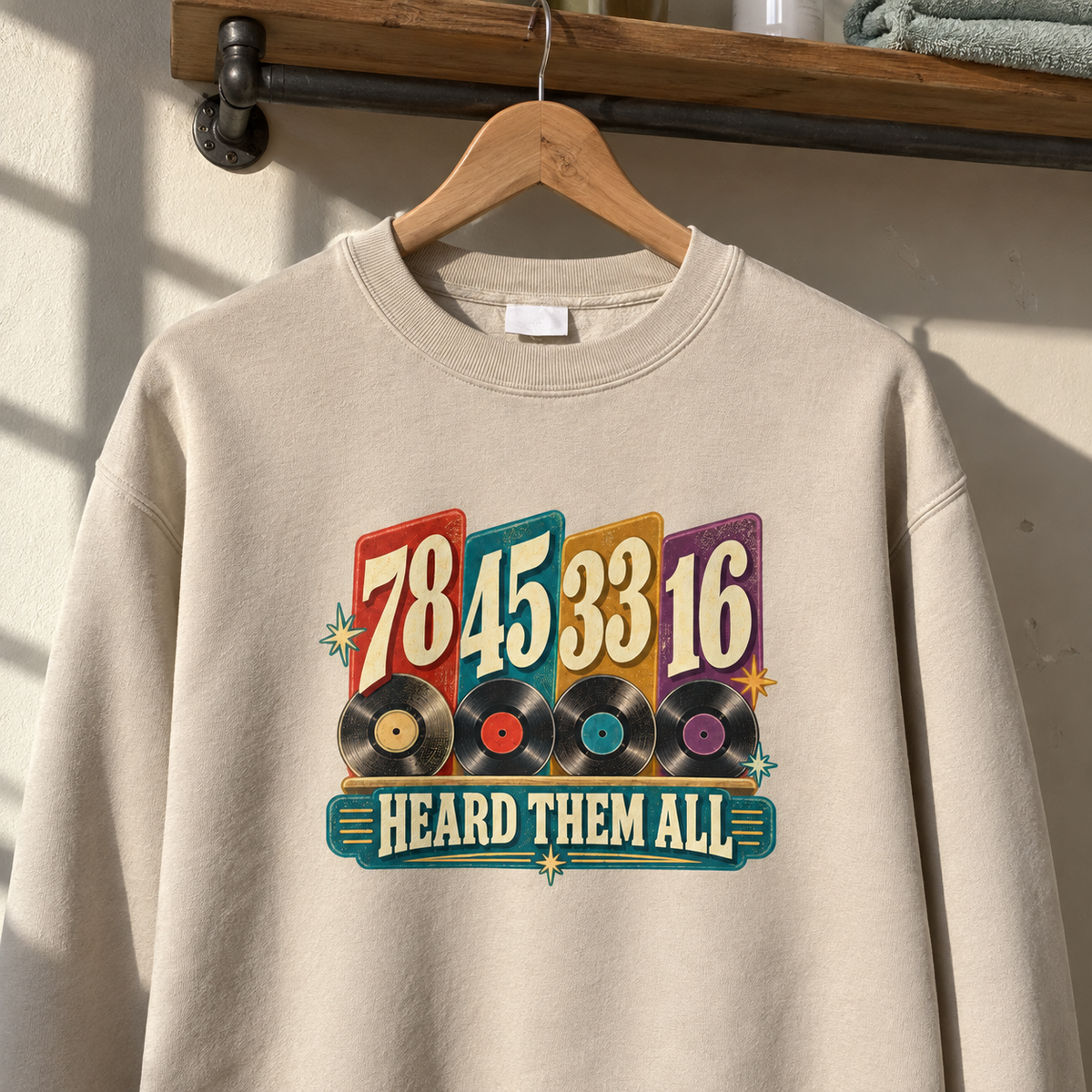 Cream vintage sweatshirt hanging on hanger, printed 78 45 33 16 Heard Them All