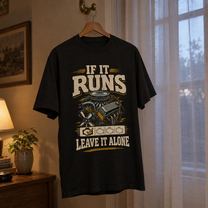 Black vintage t-shirt hanging with printed “If It Runs Leave It Alone” engine design.