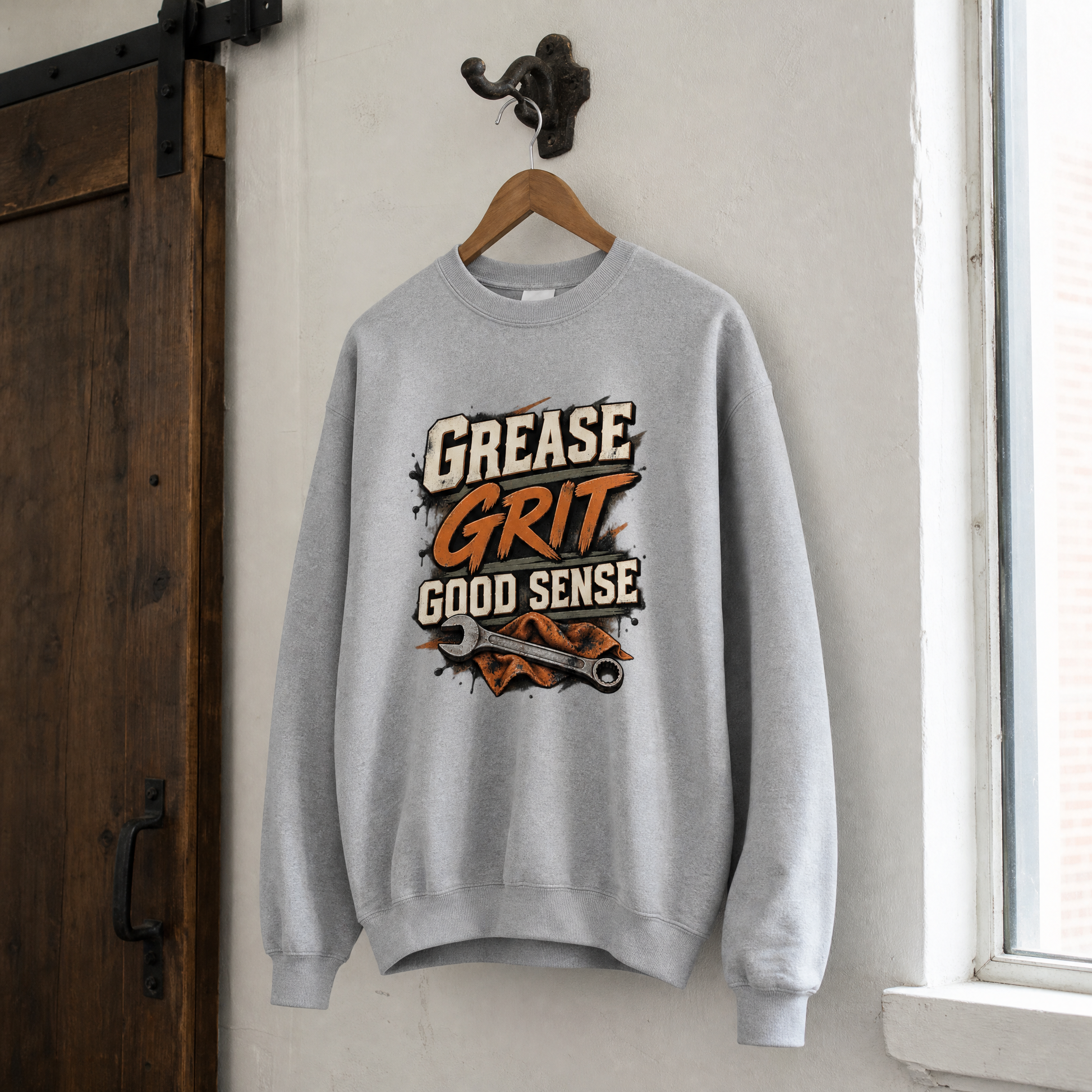Gray vintage sweatshirt hanging with Grease Grit Good Sense printed graphic design