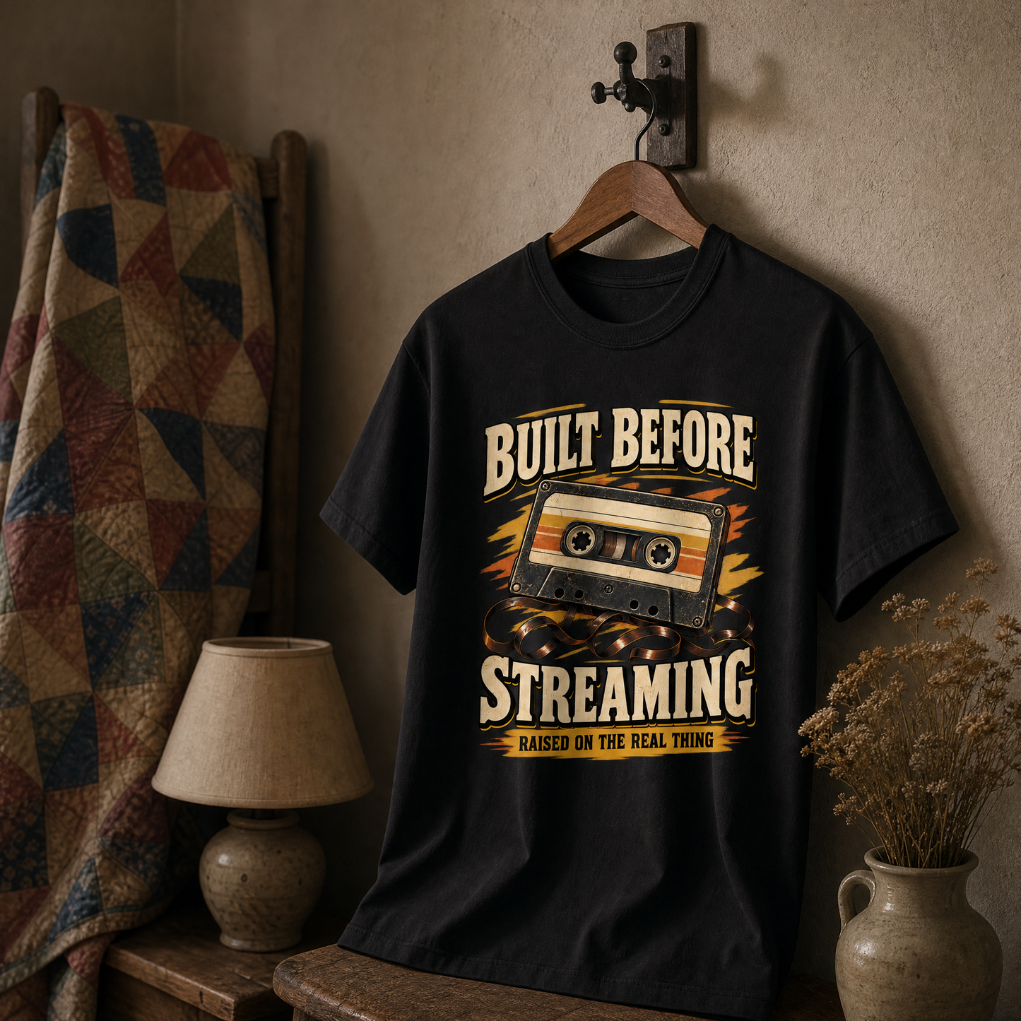 Black vintage t-shirt hanging with printed cassette design and Built Before Streaming slogan.